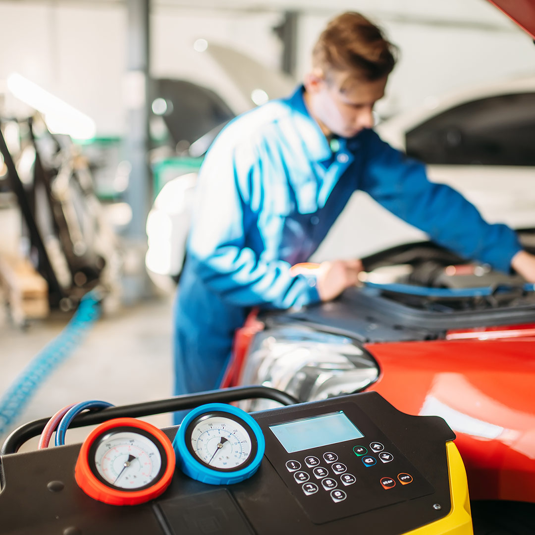Man working on a car in an auto shop